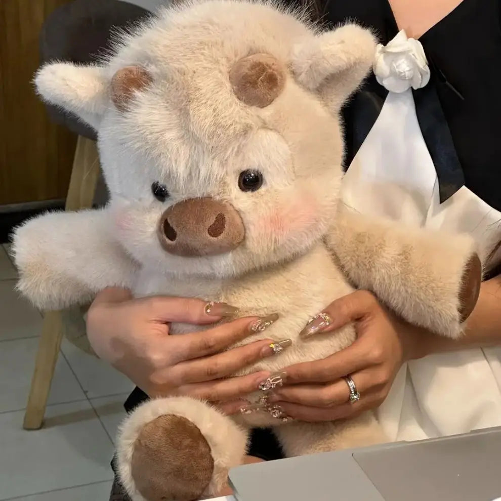 Fluffy cream-colored plush pig with soft brown accents on snout ears and feet from plush cow and pig soft stuffed animal toys for kids.