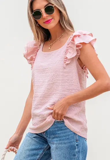 A soft pink textured square neck blouse with sleeveless butterfly sleeves and delicate ruffled shoulder details.