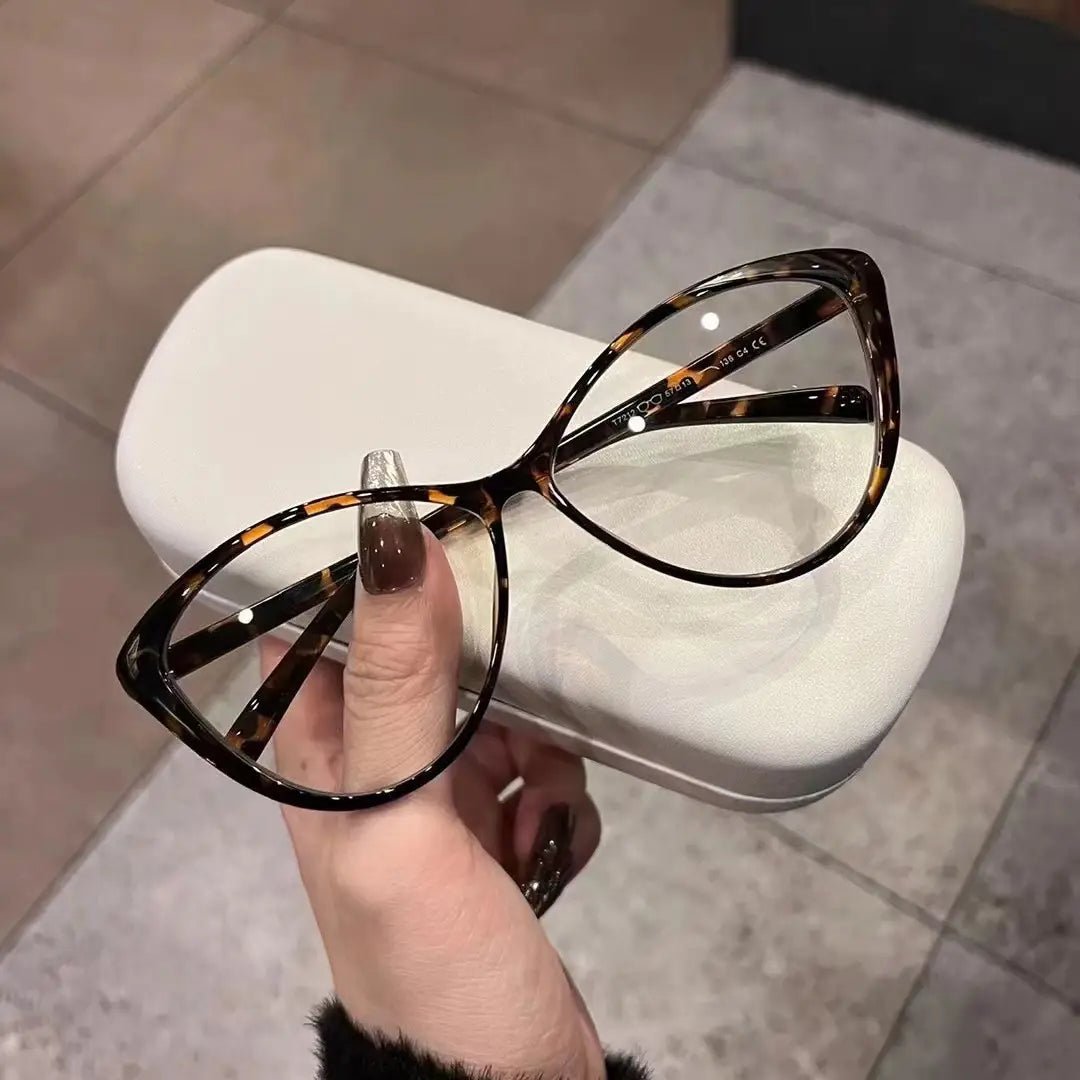 Lunettes de soleil œil-de-chat rétro UV380 légères pour la mode, associant des lunettes œil-de-chat en acétate écaille de tortue, avec un design moderne et épuré.