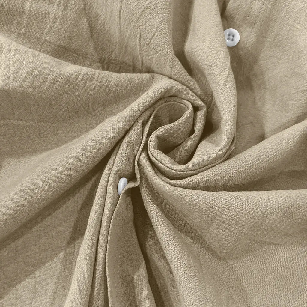 Beige linen fabric with a subtle textured weave and two white buttons on a men’s casual linen stand collar long sleeve shirt.