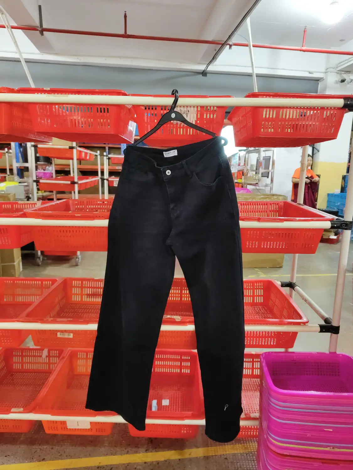 Black denim wide leg stretch jeans with classic five-pocket design and button closure