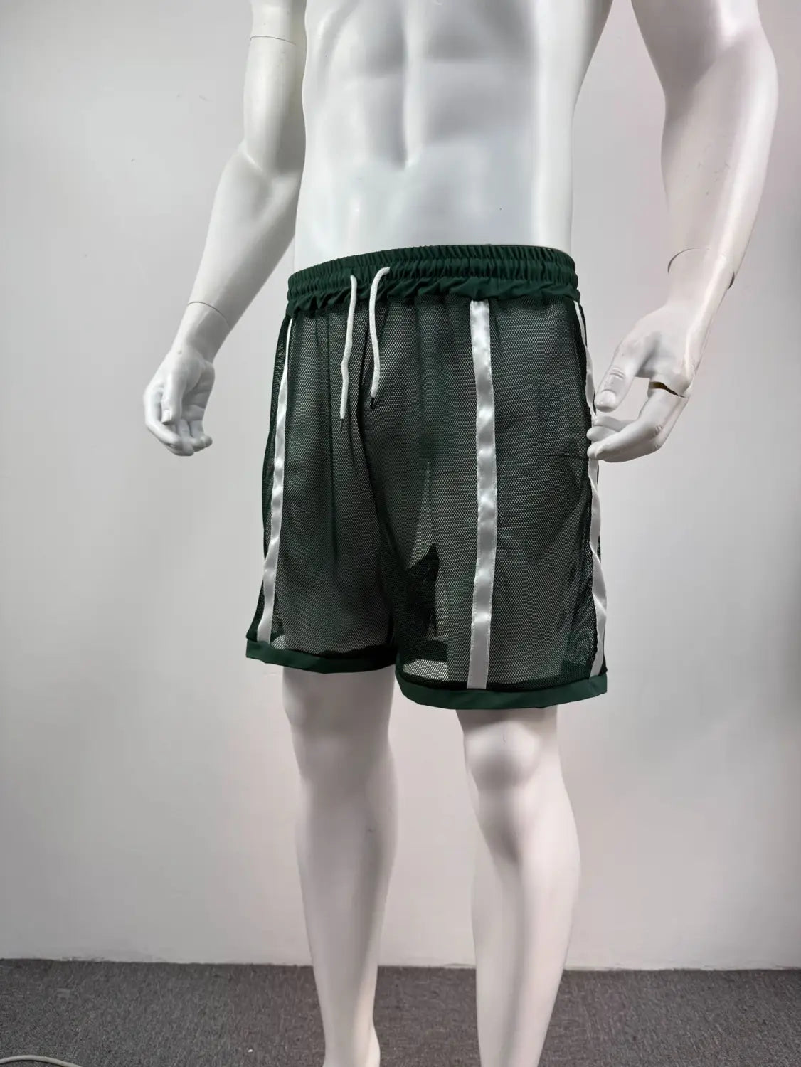 Dark green quick dry mesh athletic shorts with silver reflective stripes and a matching elastic waistband for men.