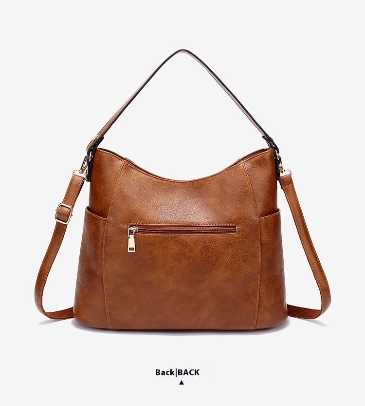 brown faux leather leather hobo bag with tassel, single shoulder strap, and front zipper pockets.