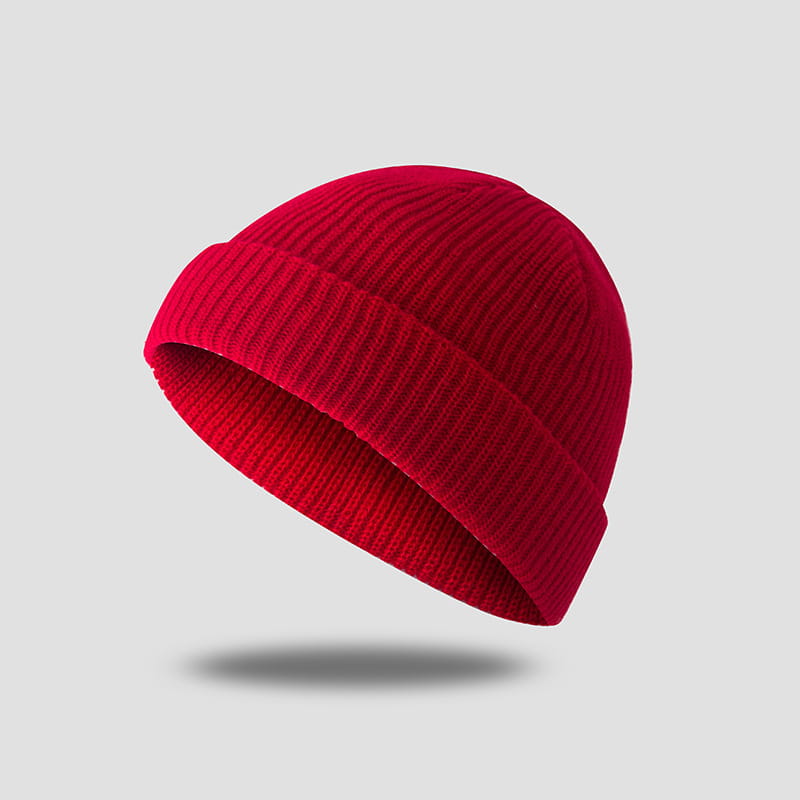 a vibrant red ribbed knit beanie with a folded cuff shown as part of a dark gray ribbed wool beanie hat collection