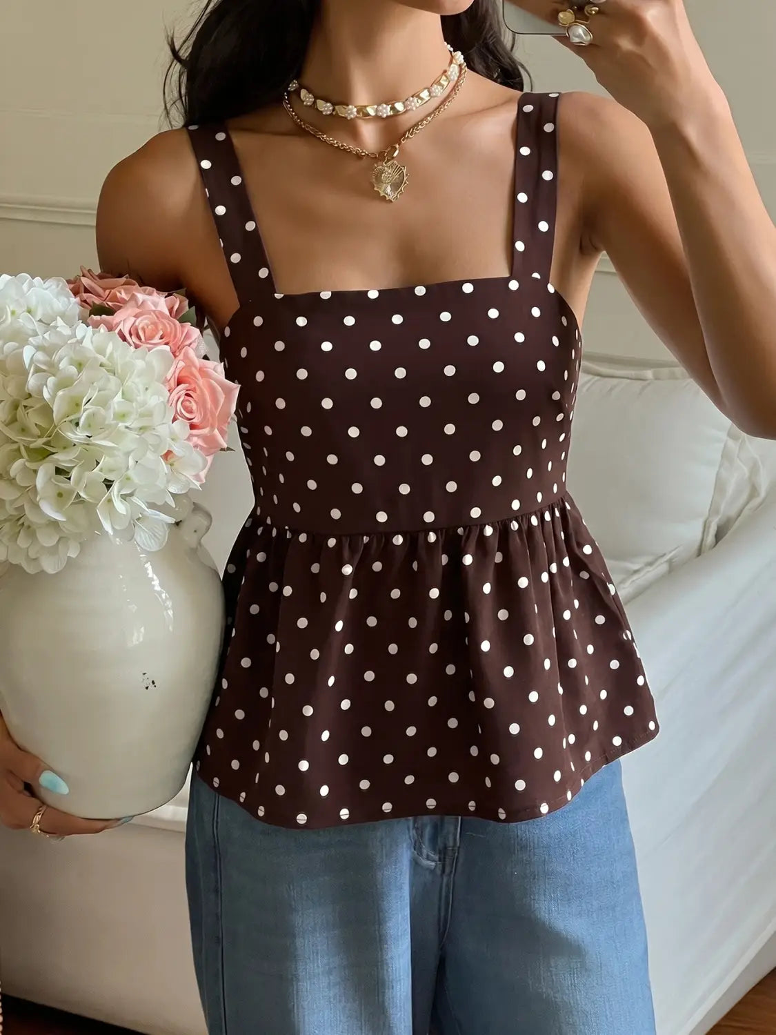 Brown polka dot peplum camisole with white dots and thin straps designed for casual wear.