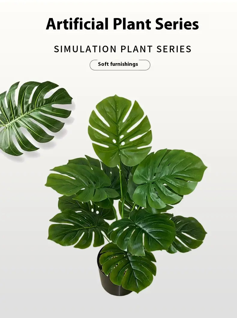 A lush deep green artificial monstera turtle leaf potted plant with glossy perforated leaves in a sleek black pot for garden decor.