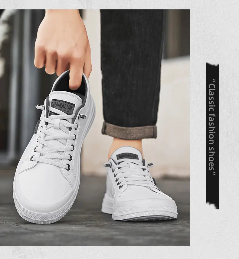 Men’s white minimalist leather casual sneakers with gray accents and black laces in a white canvas material with a minimalist design.