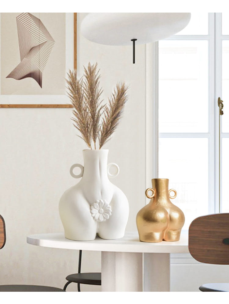 White ceramic female body ceramic vase with buttocks design and two circular handles.