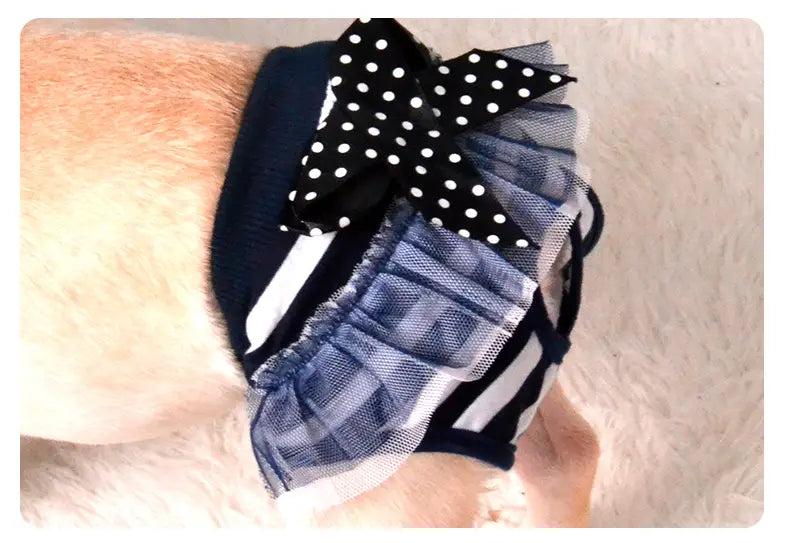 A navy blue and white striped dog physiological pants washable pet diaper sanitary shorts featuring a black polka-dot bow and sheer plaid fabric accents.