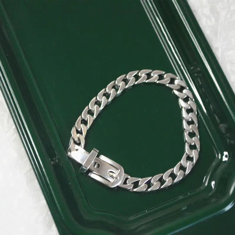 Women’s platinum plated stainless steel buckle chain bracelet featuring a silver-toned curb link design with a polished reflective finish and matching buckle clasp.