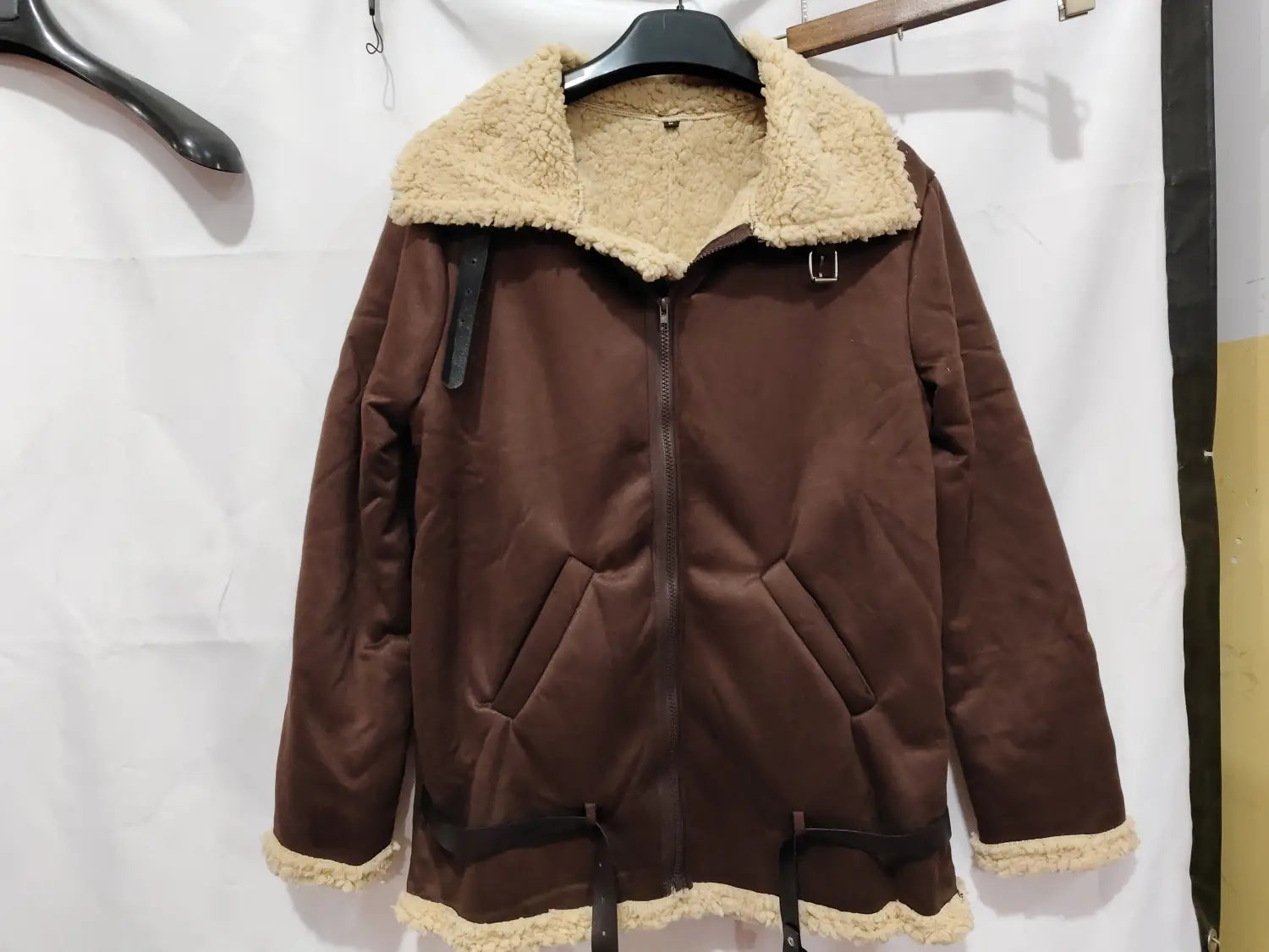 Men shearling bomber jacket in brown with quilted exterior and shearling-lined collar cuffs and hem.
