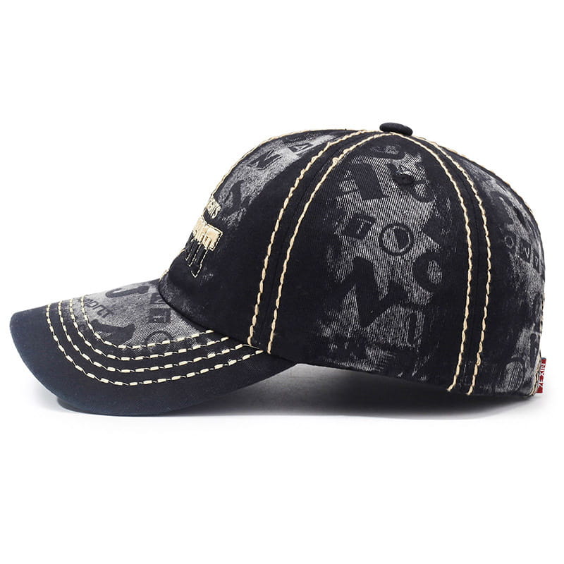Black distressed washed cotton baseball cap featuring a gray graphic pattern and contrasting cream-colored stitching.