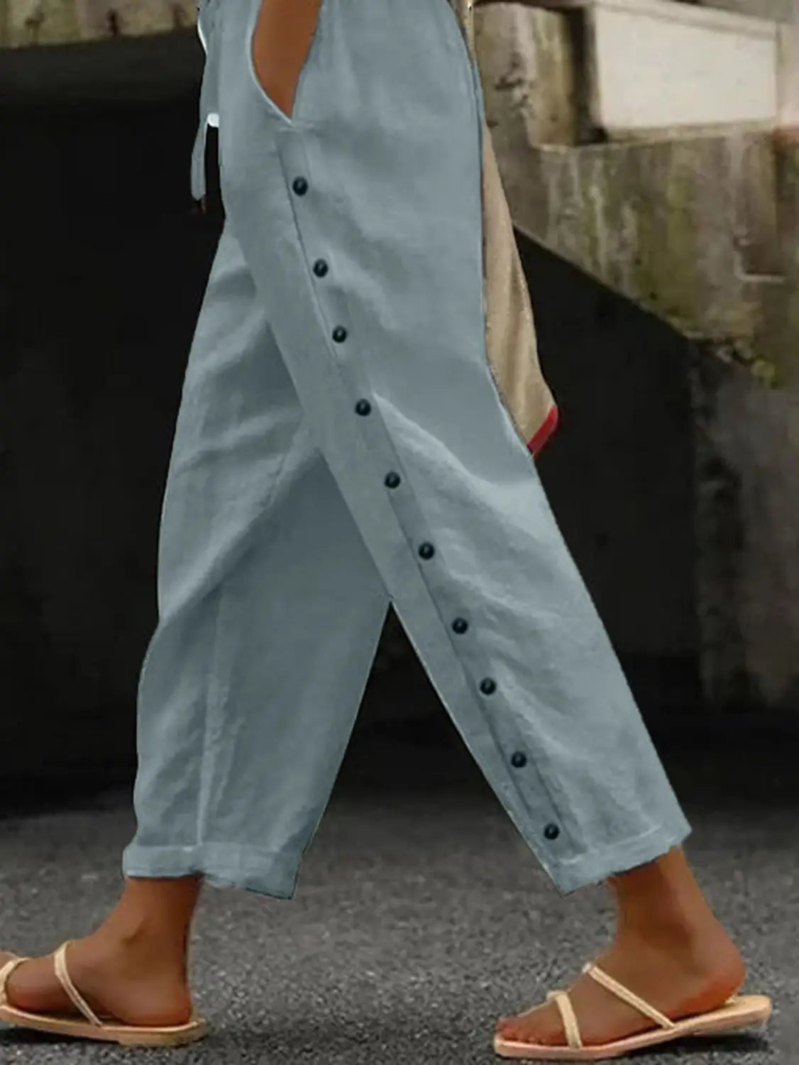 Light blue linen cropped patchwork casual pants for women featuring black buttons down the side seam.
