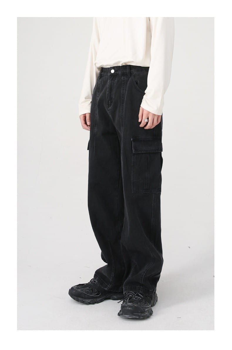 Black denim cargo pants with large side pockets and a relaxed fit featuring a retro loose fit wide leg design.