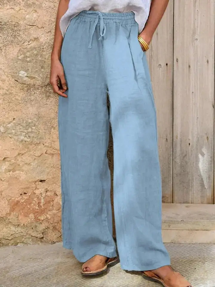 light blue drawstring linen wide leg pants with an elastic waistband designed for a loose fit and comfortable wear.