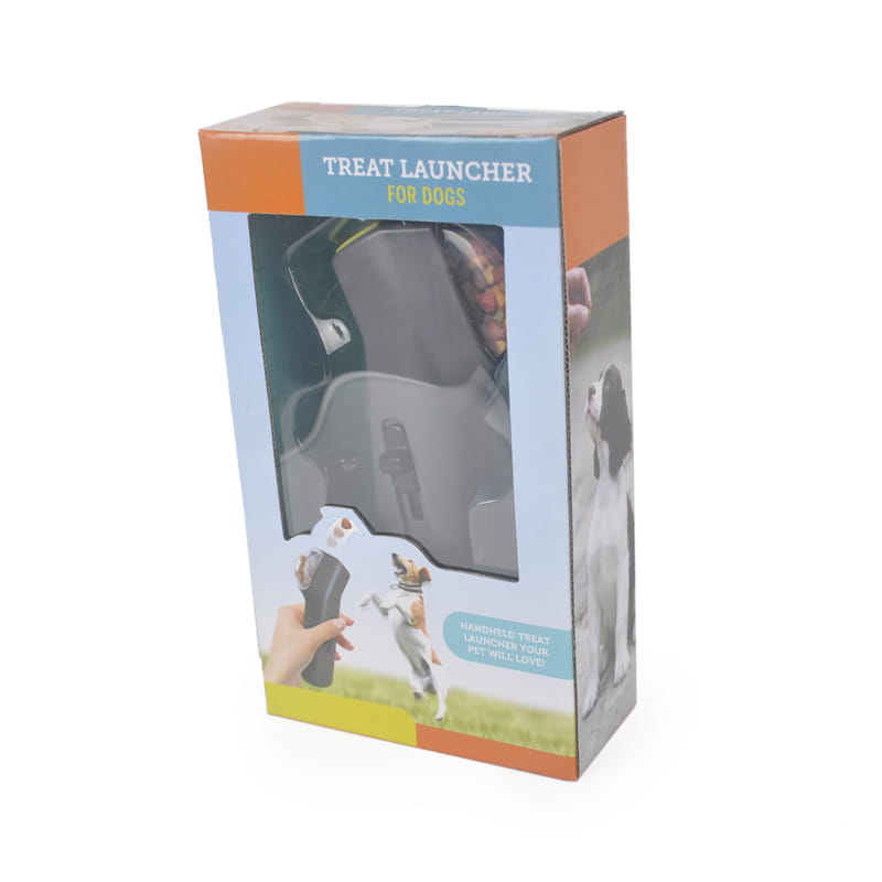 Gray plastic dog training snack launcher with handheld grip and trigger mechanism designed for pet treat shooting.