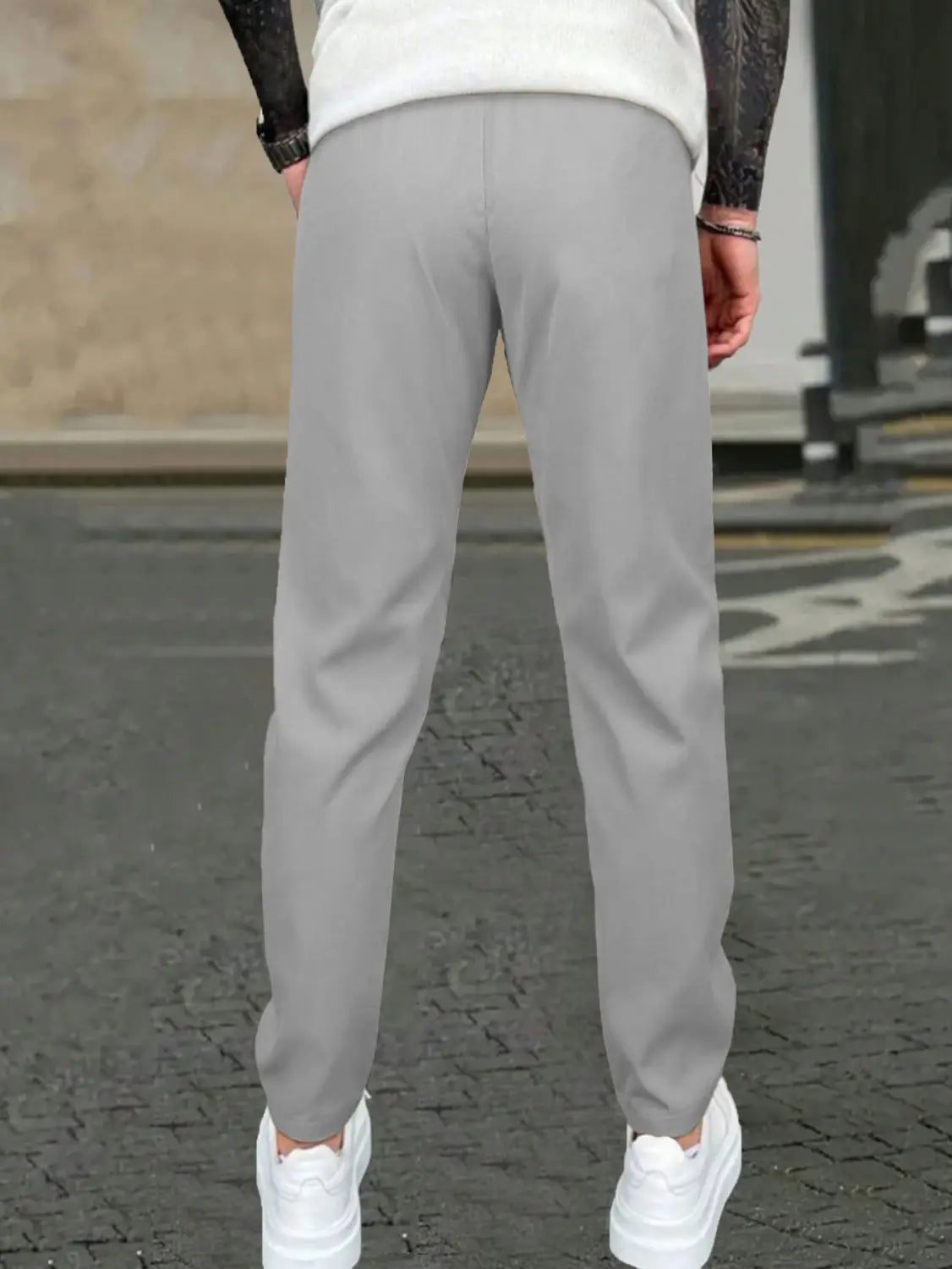 Gray slim fit tapered jogger pants with drawstring featuring soft stretchy fabric and subtle side seam detailing.