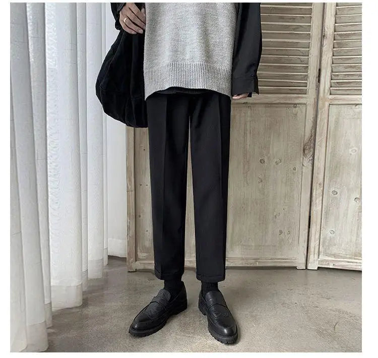 Men loose fit straight leg suit pants in black with a smooth slim-fit cut and neatly cuffed hems.