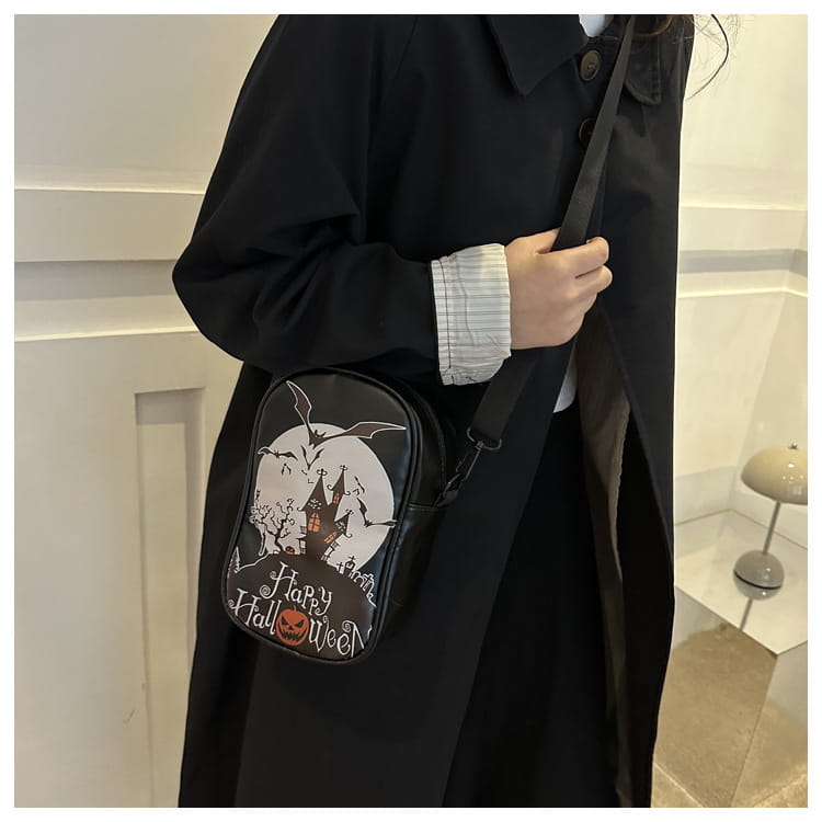 Black embroidered Halloween floral and pumpkin crossbody bag featuring a spooky castle bats and jack-o-lantern design for seasonal use.