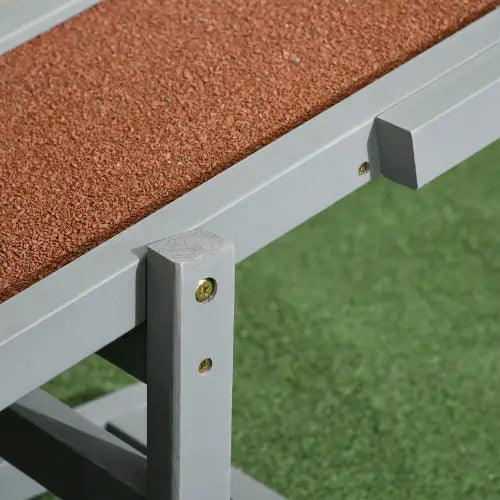 gray metal frame dog agility seesaw training equipment with textured brown cork surface