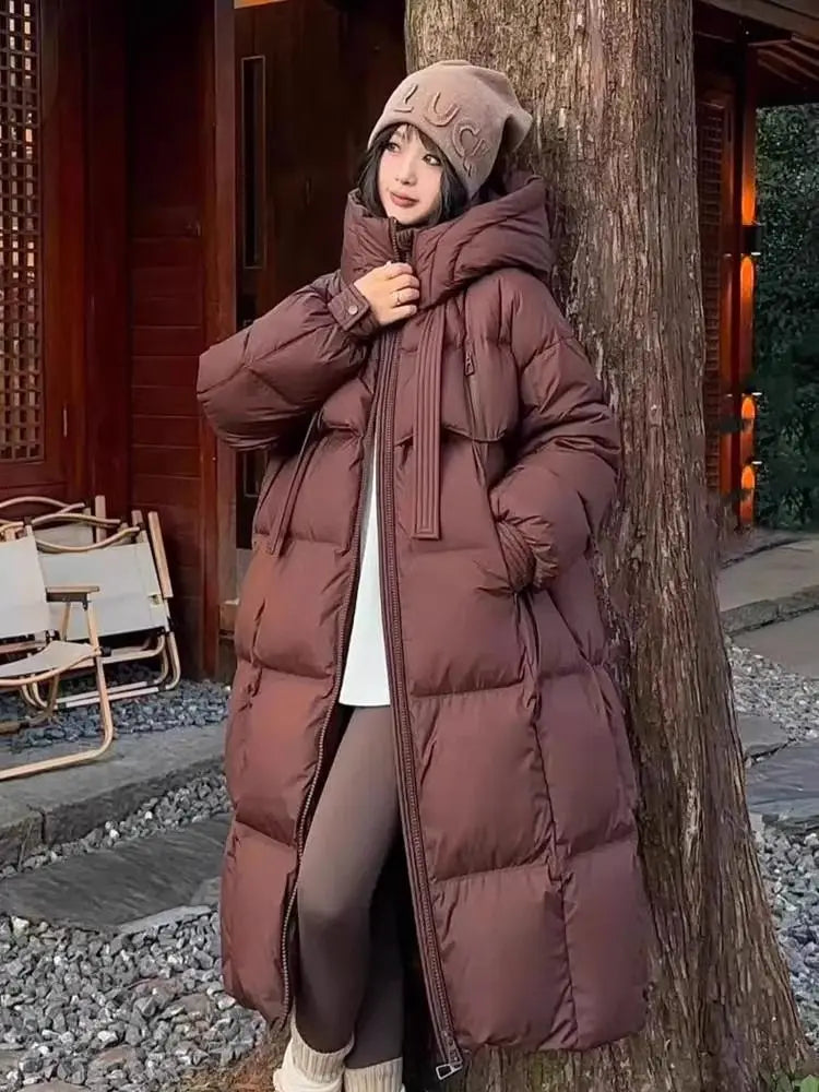 a cozy long brown puffer coat with a quilted design and a hood for women long padded down jacket quilted coat