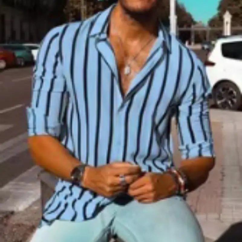 A light blue and black vertically striped casual long sleeve button down shirt for men with rolled sleeves.