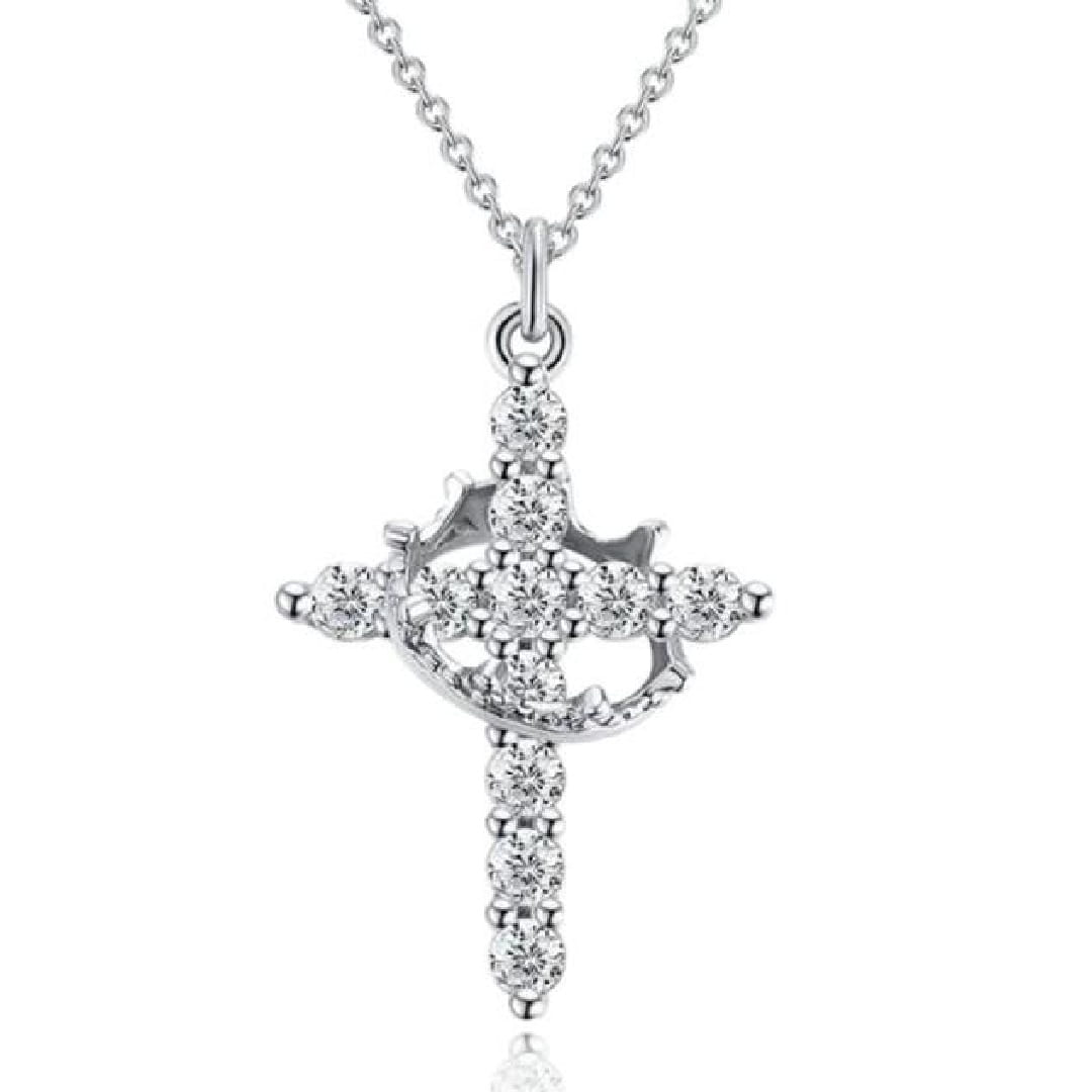 A sparkling layered crown and cross pendant necklace featuring a silver cross pendant adorned with numerous clear round cut diamonds on a delicate chain.