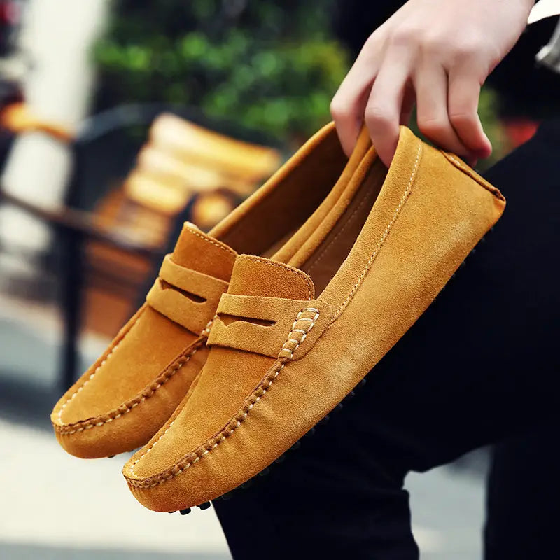 Mocassins en daim classiques camel, avec surpiqûres contrastées, présentant un design intemporel.