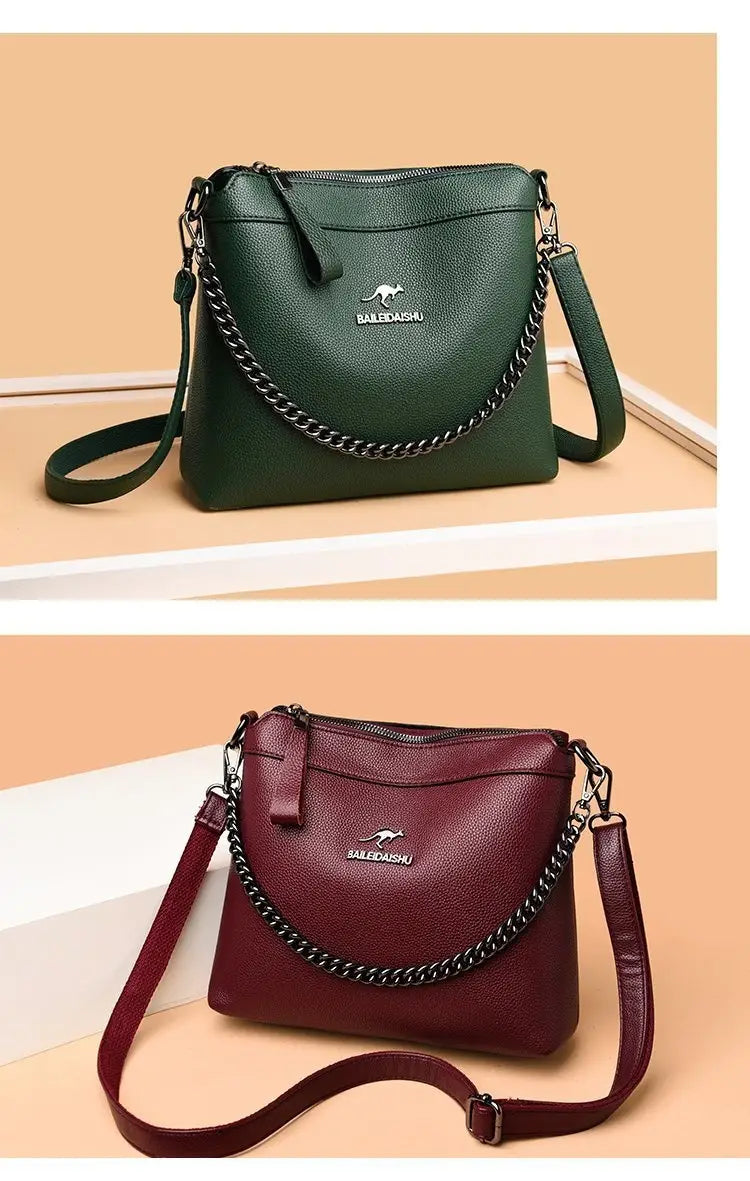 Leather crossbody handbags in dark green and burgundy leather featuring a silver chain strap with the Balenciaga logo.