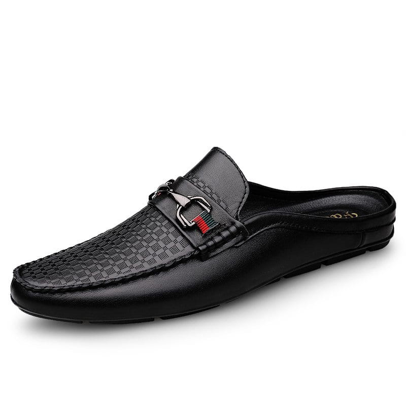 Black leather men’s mule loafers with woven texture on the toe and a silver horsebit buckle accented by red stitching.