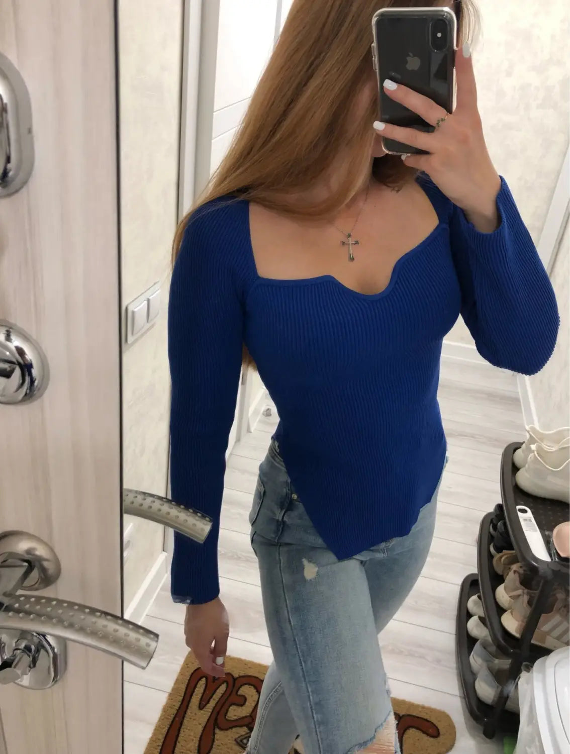 A vibrant royal blue ribbed knit pullover with long sleeves, a square neckline, and asymmetrical hem.