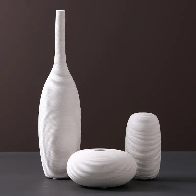 Set of three white ceramic vases with textured ribbed surfaces and minimalist modern designs for nordic home decor.