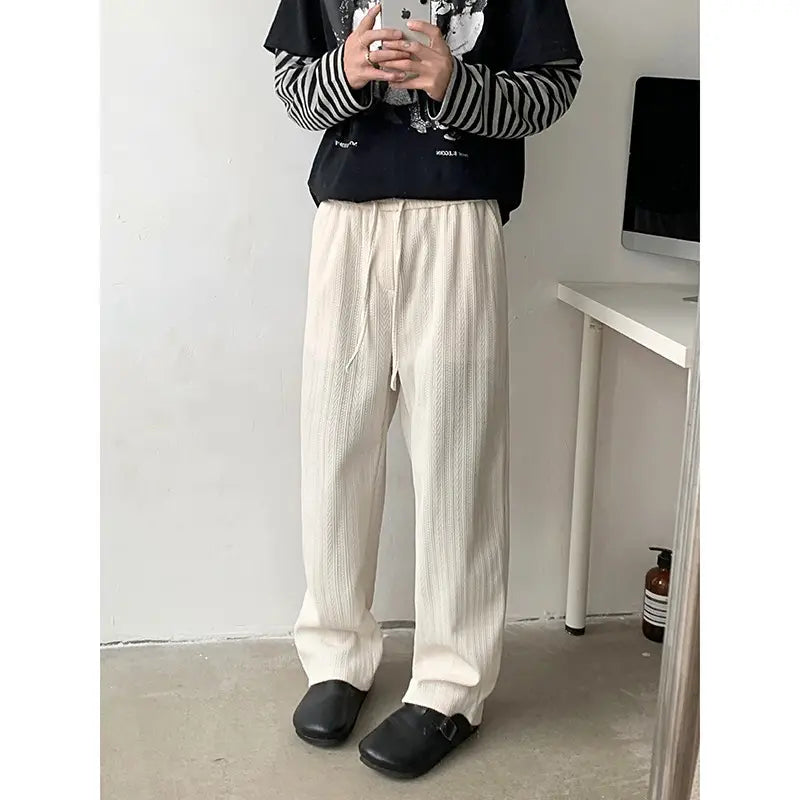 Cream-colored ribbed cotton wide leg corduroy drawstring pants with a comfortable waist design.