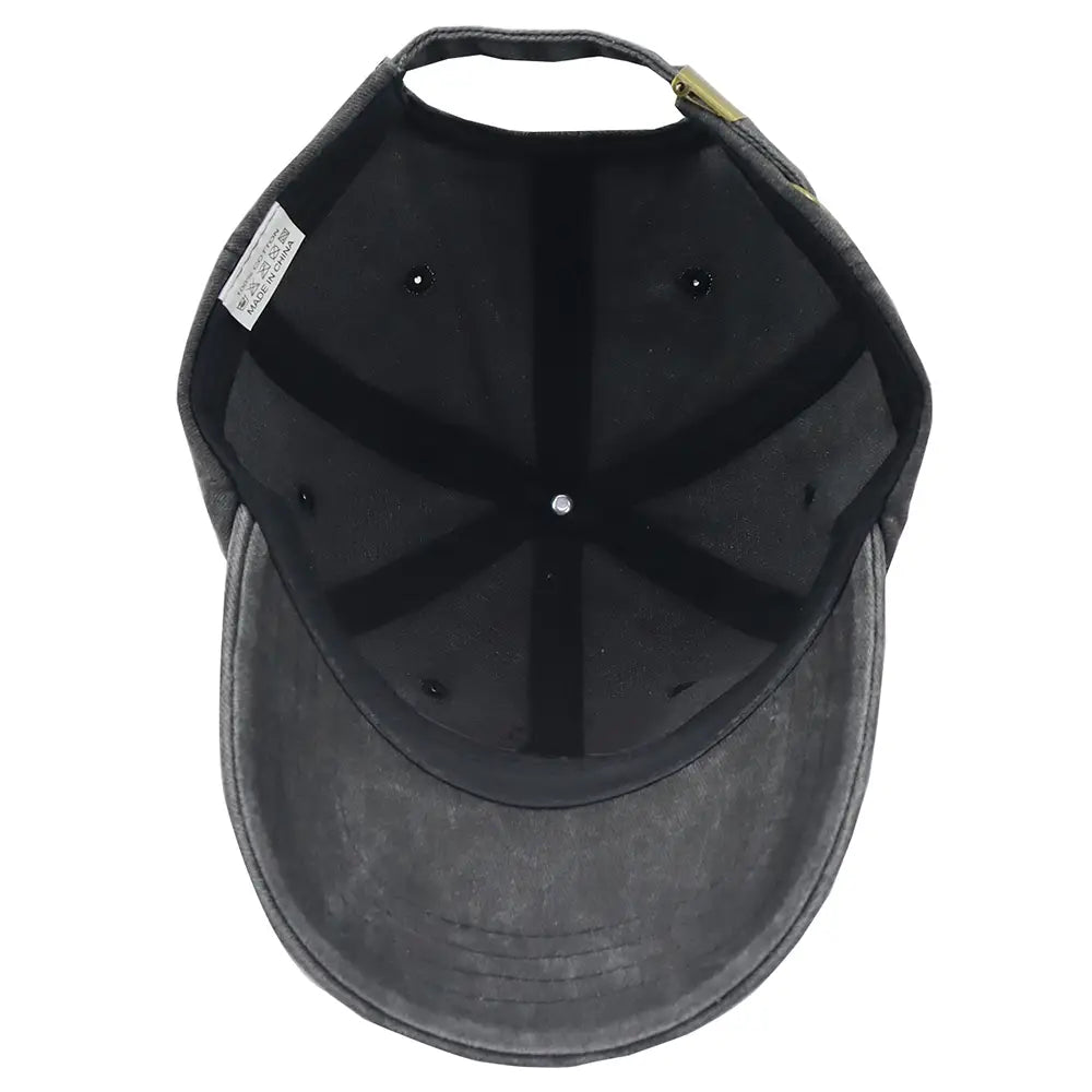 black denim elephant embroidered vintage washed cotton baseball cap shown from the back with a faded worn texture and a small gold-colored zipper closure.