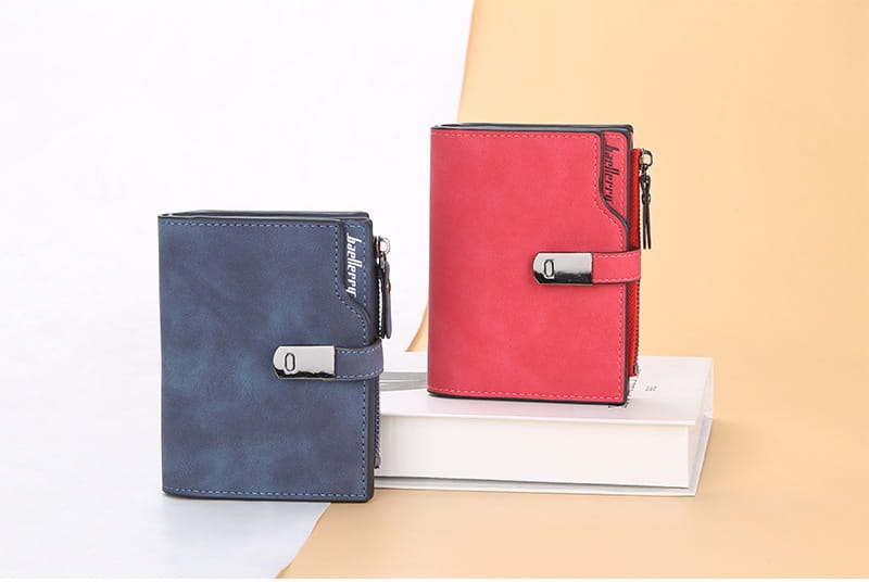 A women’s short faux leather multi slot wallet in sleek navy blue and vibrant red with a textured finish and silver-toned metal clasps and zippers.
