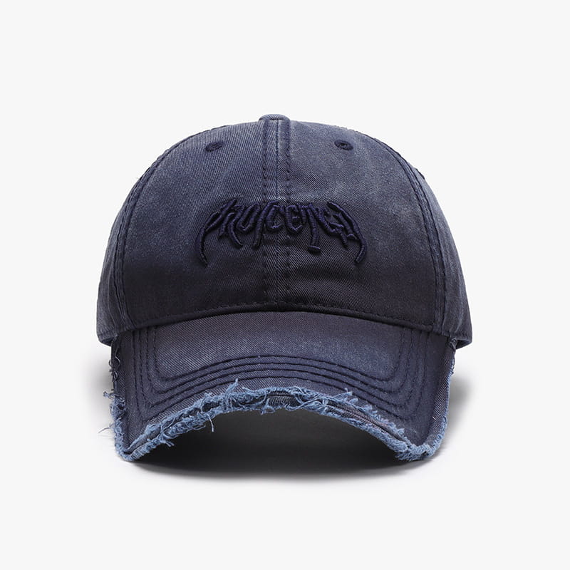 Distressed cotton dark blue denim baseball cap with frayed brim and black embroidered logo.