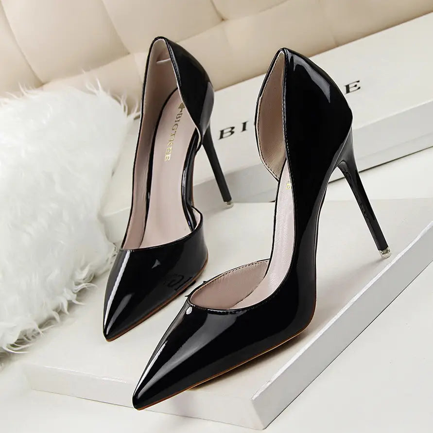 Black patent leather high-heeled pumps with a sleek pointed toe and thin stiletto heel.