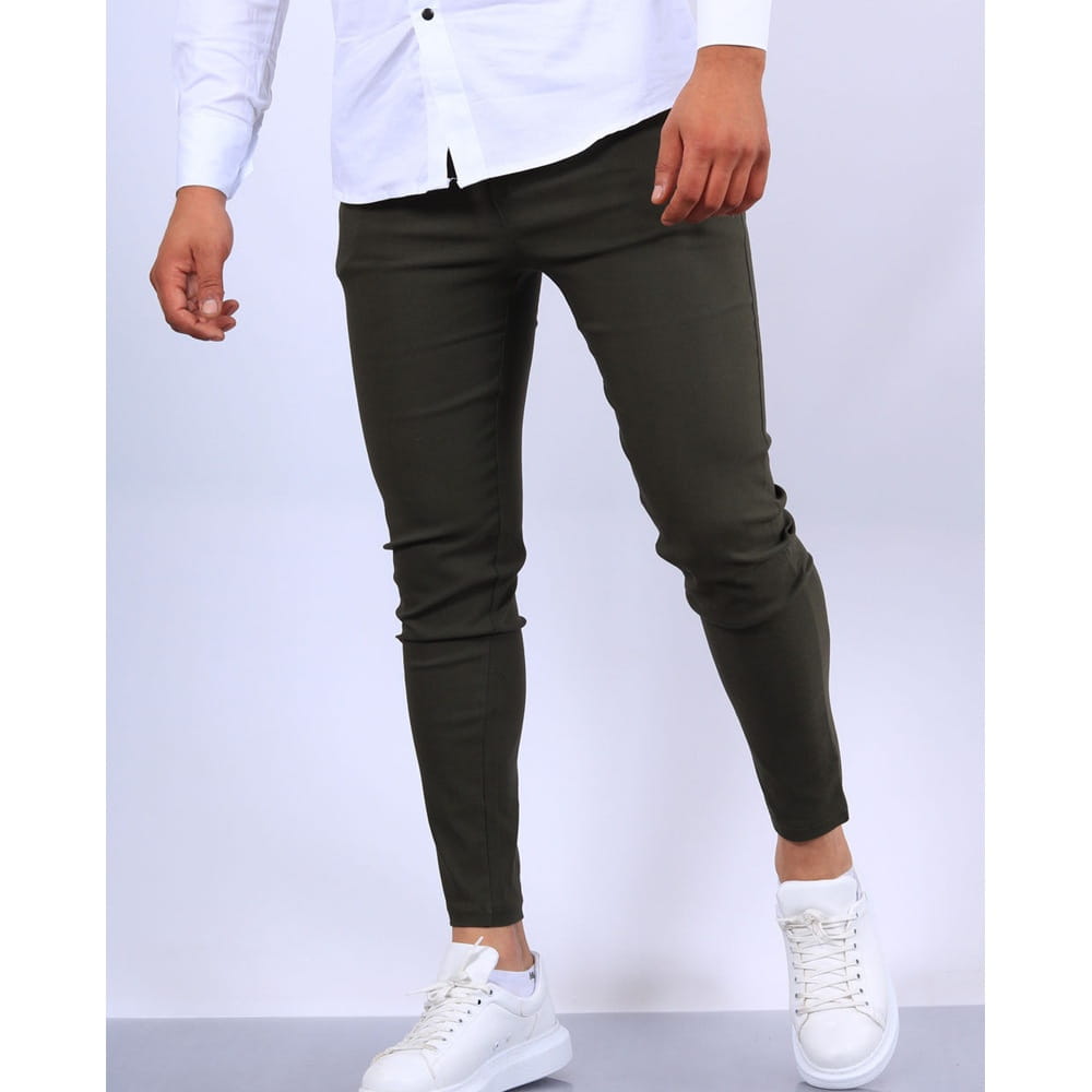 Men’s slim fit modern cotton blend pencil trousers in dark olive green made of smooth stretchy fabric with subtle creases and tapered leg design.