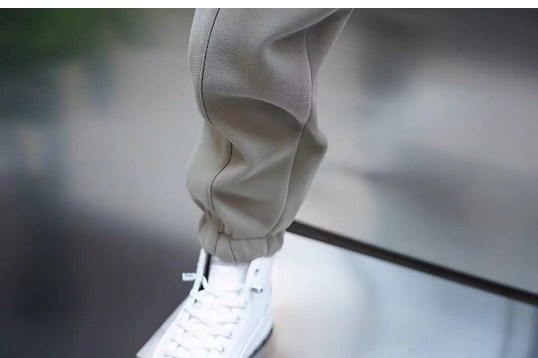 Mens casual solid color sweatpants in khaki with tapered leg and visible stitching details designed for comfortable everyday wear.