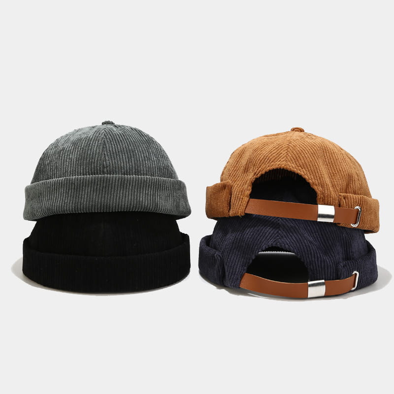 Gray and brown corduroy landlord beanie hats with adjustable leather straps shown from the back side suitable for streetwear use.