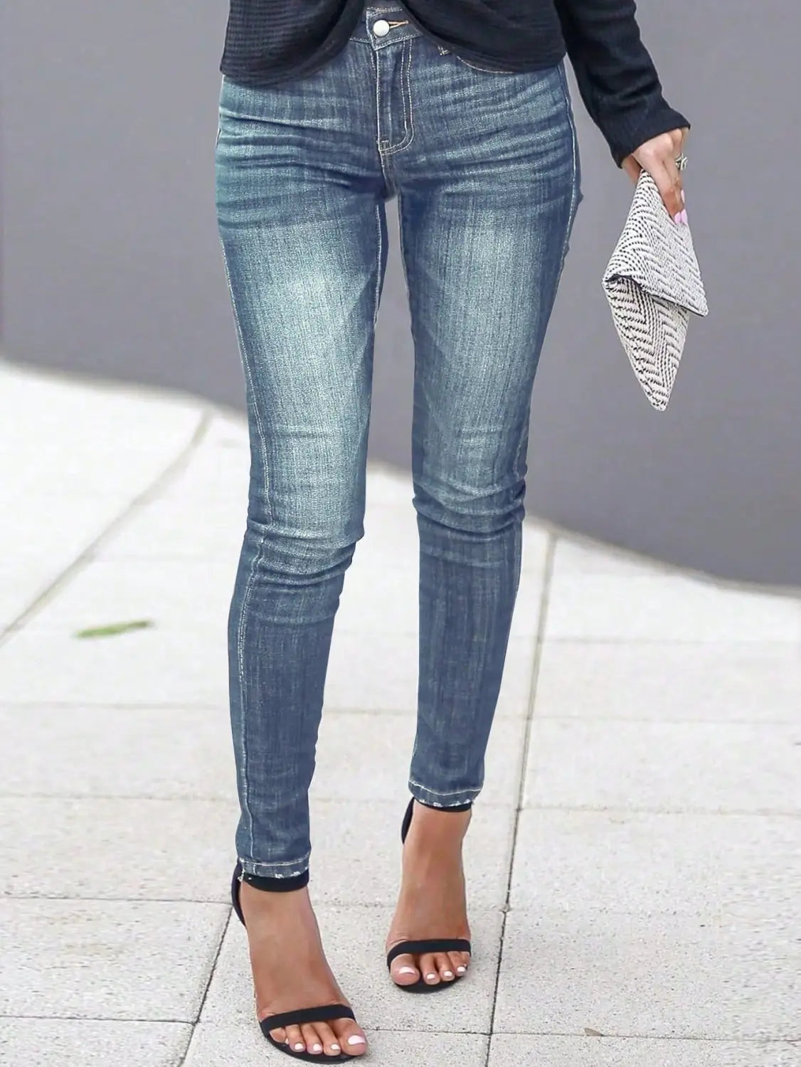 women’s high-waisted stretch skinny jeans in blue denim with a faded wash and classic five-pocket design.