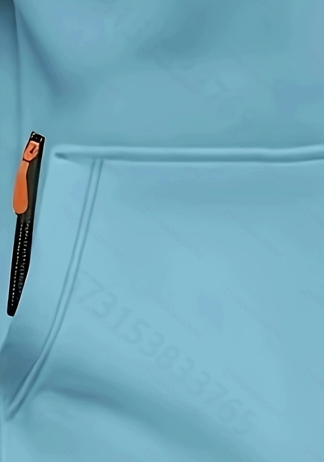 A sleek black pen with an orange clip rests in the pocket of a light blue men’s sport casual fleece lined zipper hoodie jacket.