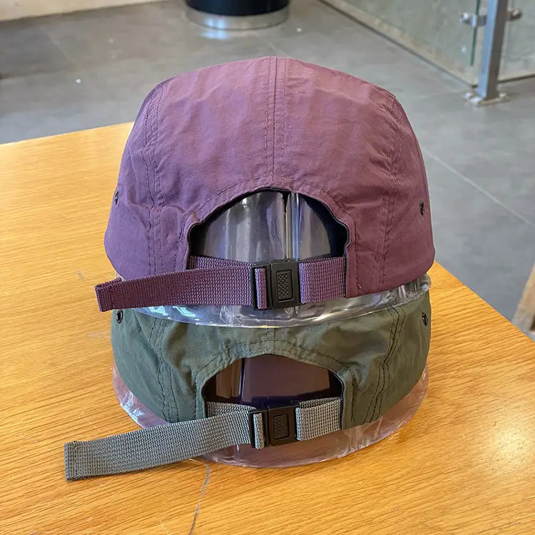 purple and olive green quick drying short brim five panel baseball caps with adjustable straps shown from the back side