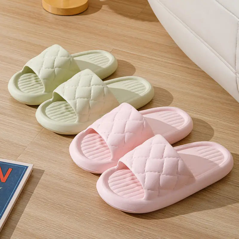 Quilted non slip lightweight home slide sandals in pastel pink and mint green rubber with a cushioned sole.