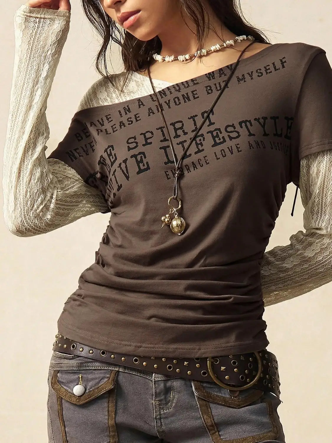 Dark gray lace layer off shoulder knitted top with sheer lace long sleeves and black printed text on front.