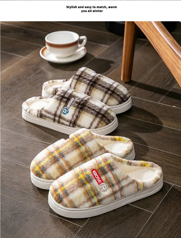 Unisex plaid fleece lined slip-on slippers with white rubber non slip soles and a branded logo patch.