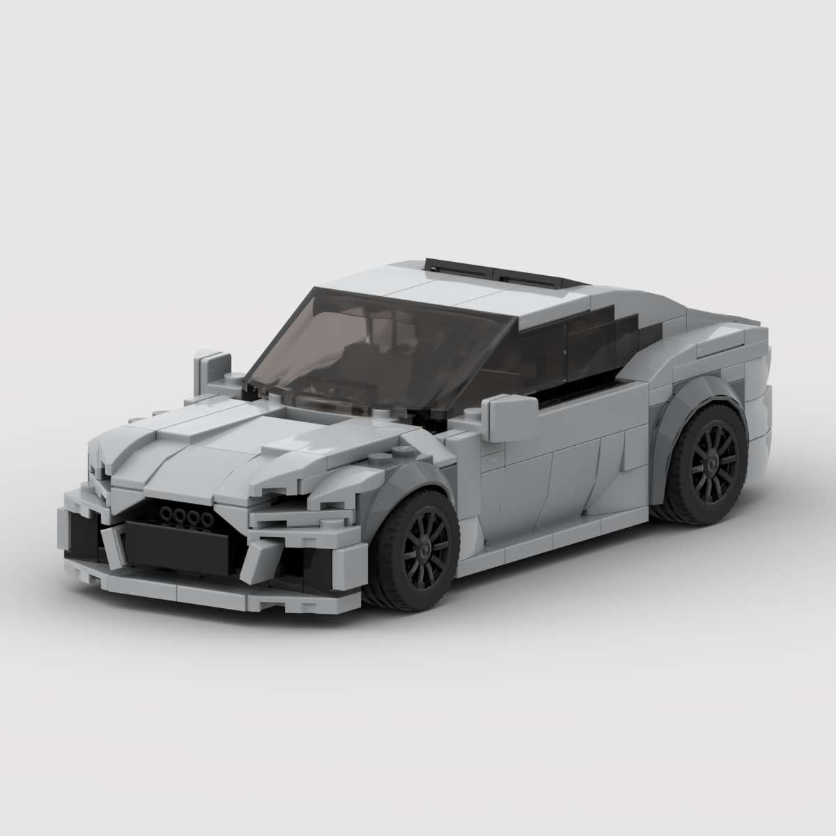 Modelo de juguete de coche deportivo Audi RS7 construido con LEGO gris, con ruedas negras y ventanas transparentes mostradas desde el lado trasero.