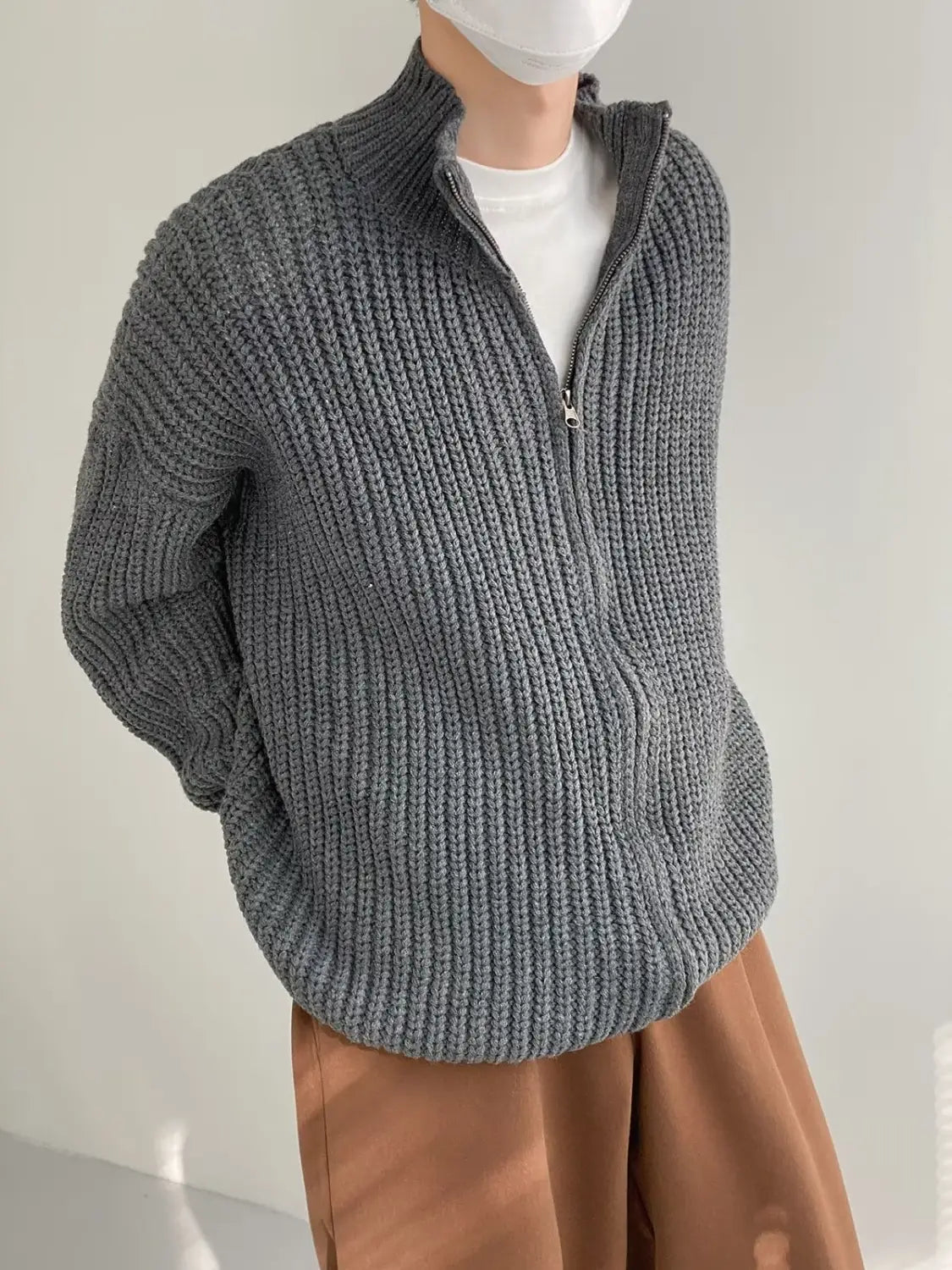 Men’s ribbed knit zip up sweater cardigan in gray featuring a half-zip design with a high collar and textured vertical stitching.