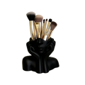 Black ceramic abstract face makeup brush holder shaped like a woman’s head with hands framing her face