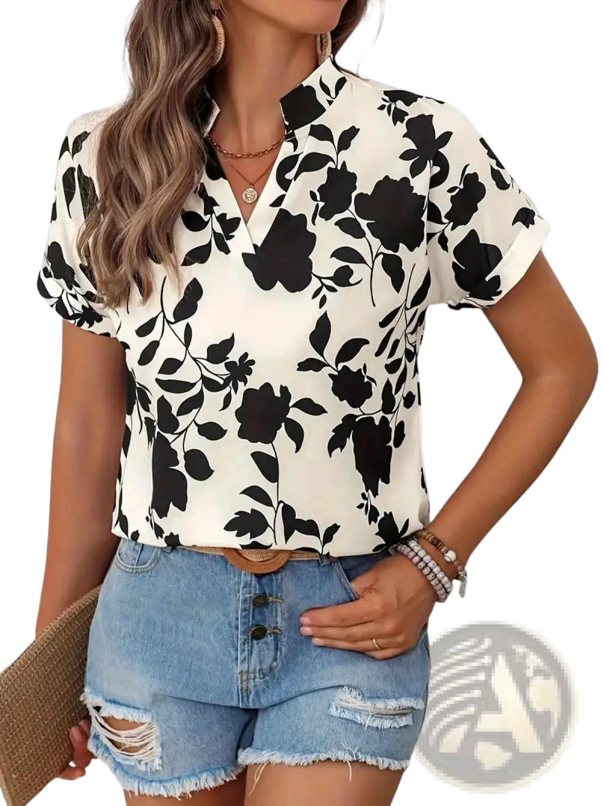 A woman wears a black and white floral print abstract print v-neck stretch satin blouse with short rolled cuffs